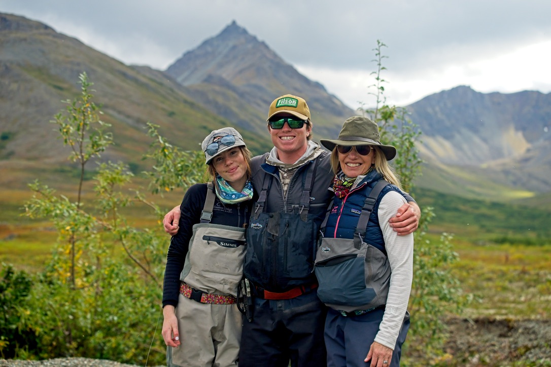 Sarah with two fellow travelers in a wide Alaskan river valley